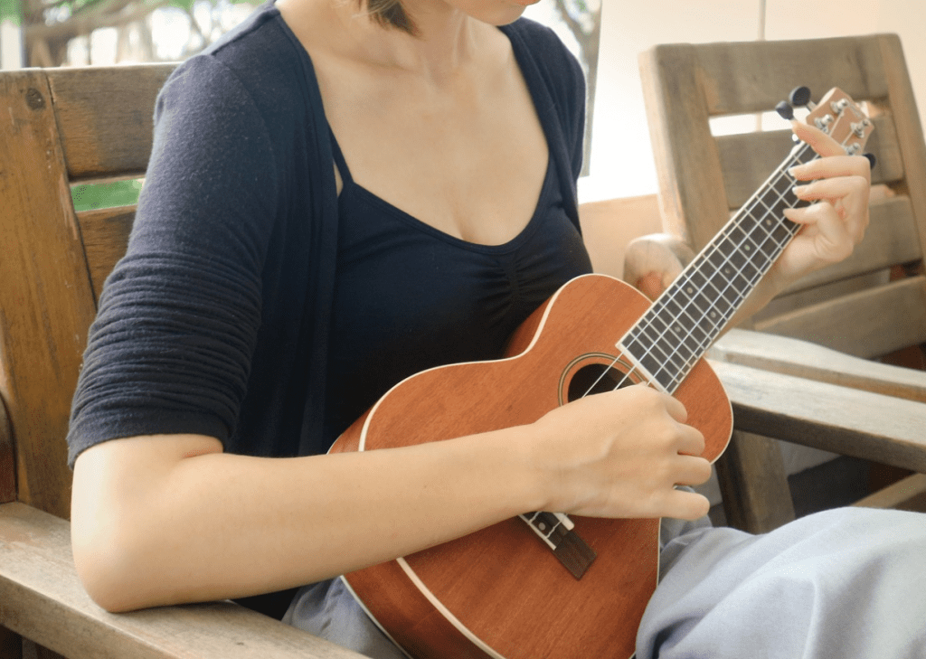 strumming ukulele